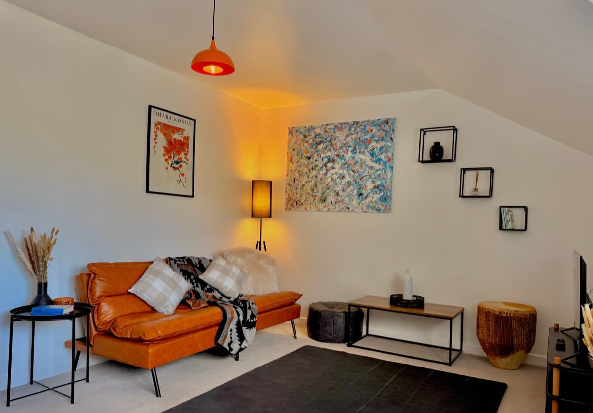 Cheddar — lounge with tan leather sofa